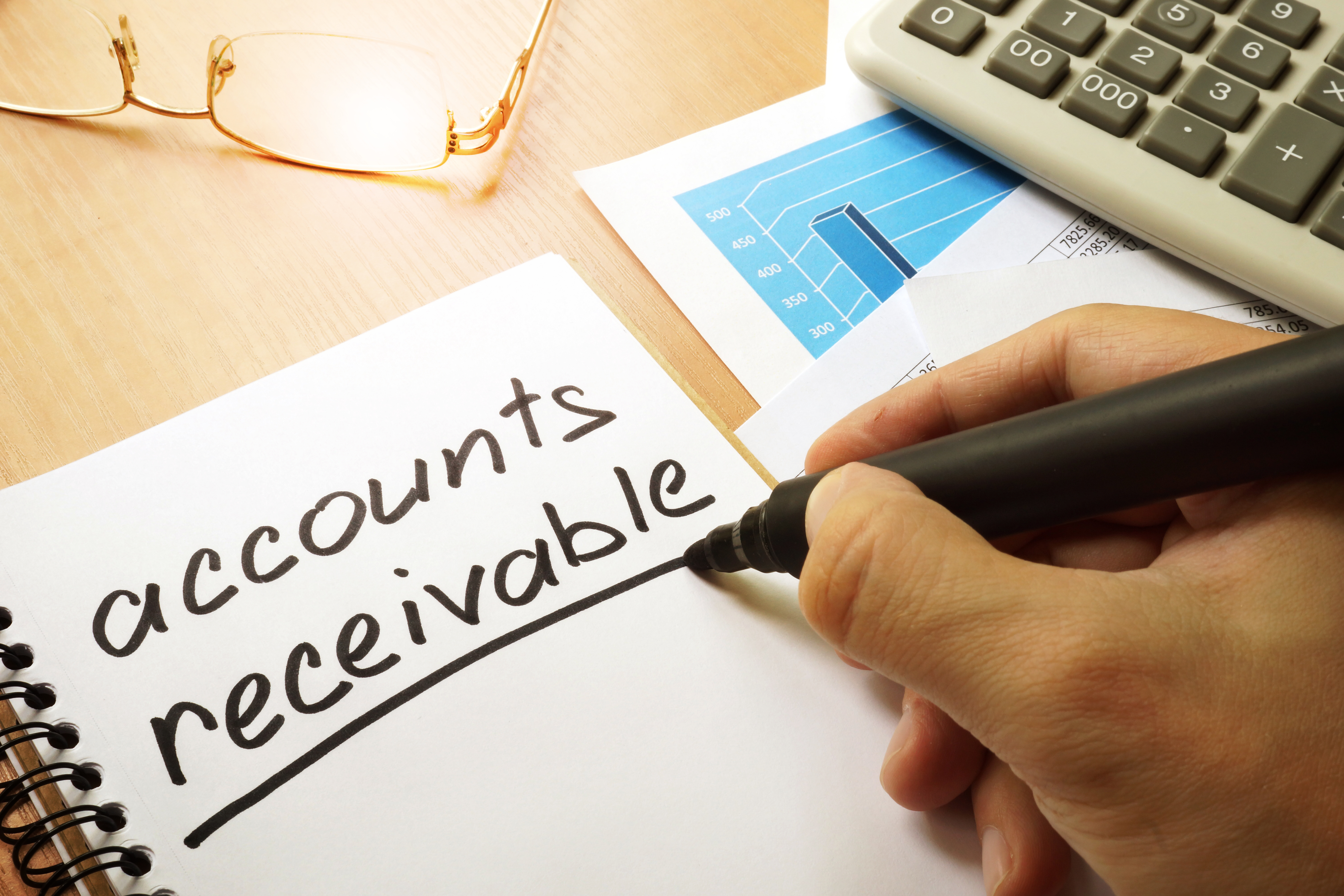 Accounts receivable written by hand in a note.